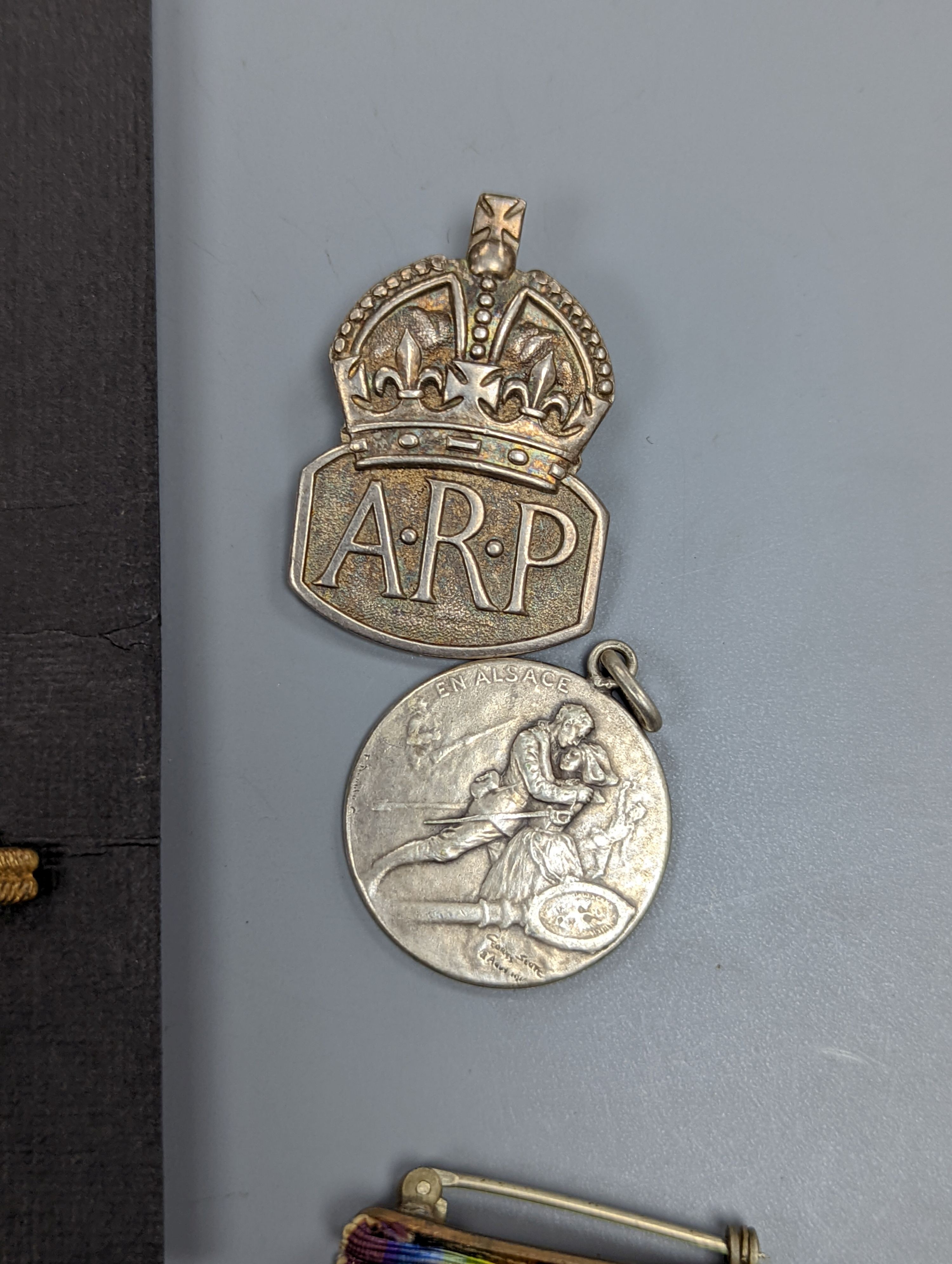 A George VI Territorial For Efficient Service medal, ARP, On War Service, Women’s Land Army badges, UN medal and other badges and medals and a quantity of reference books